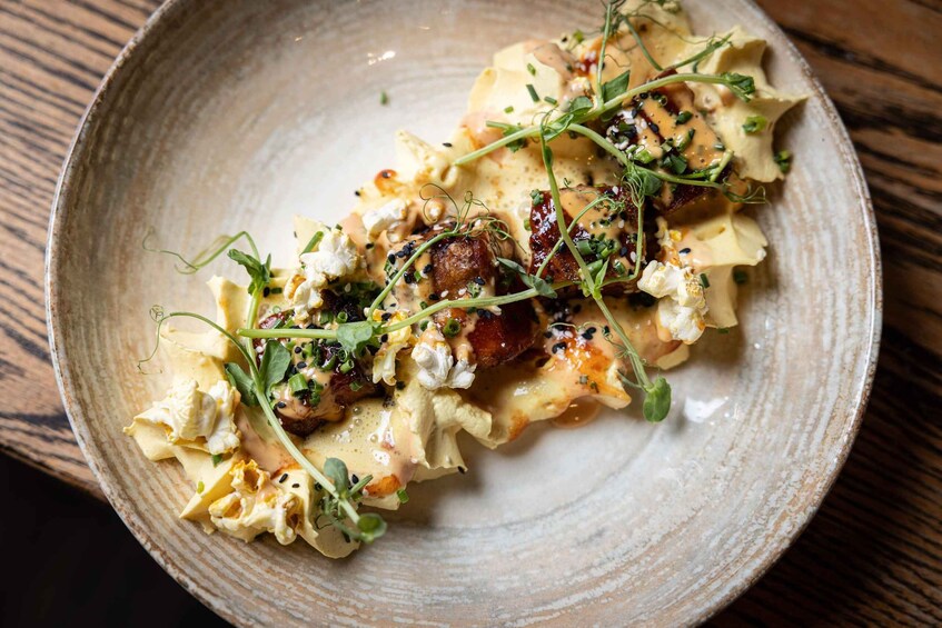 A plate of pasta with greens and cheese. 3
