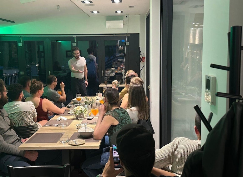 A group of people dining at a restaurant with a modern interior and a view of the cityscape. 2