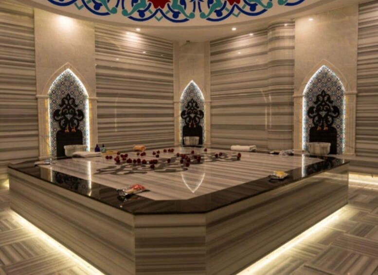A luxurious interior with a marble reception desk, decorative arches, and patterned walls. 2