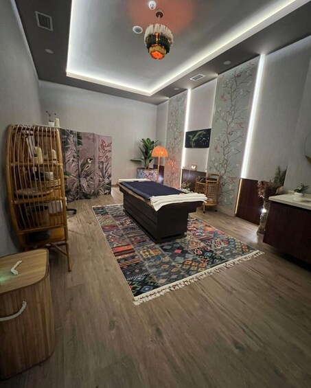 A modern bedroom with a bed, a wooden chair, a patterned rug, and a ceiling light fixture. 5