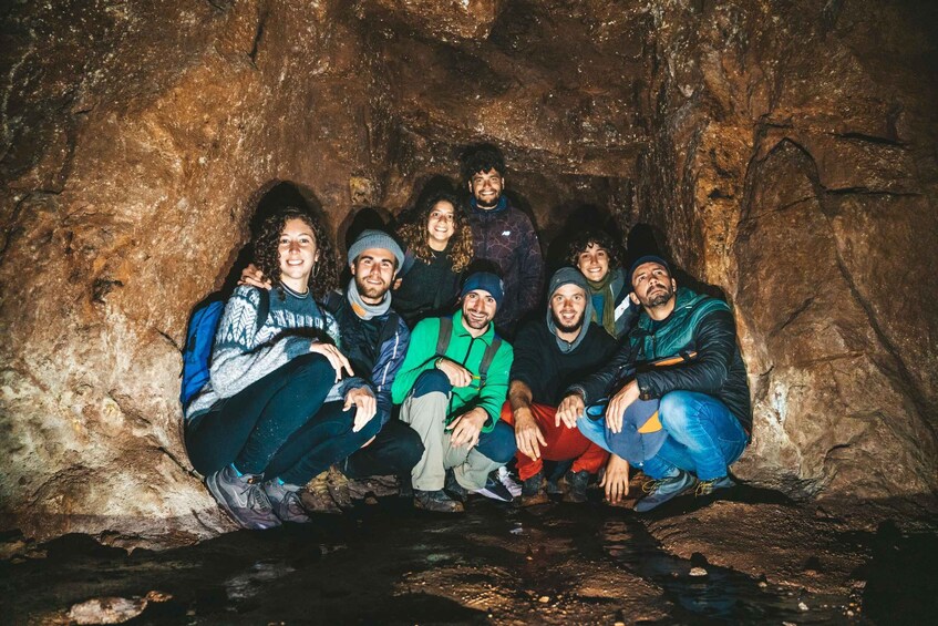 A group of people sitting in a cave. 2