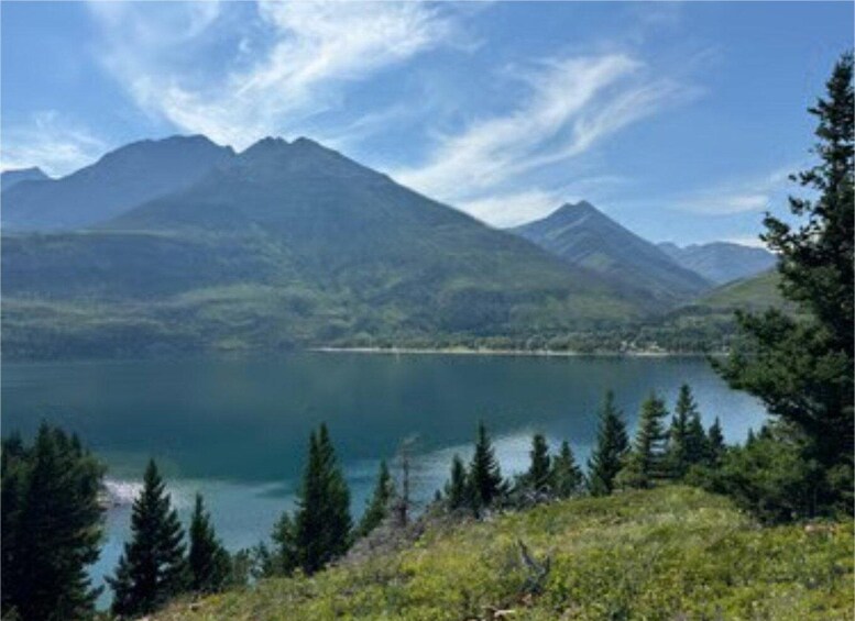 A mountain lake with coniferous trees and distant mountains. 2