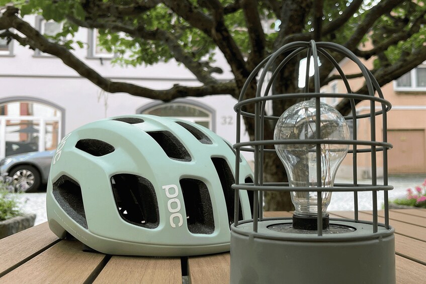 A helmet and a light bulb on a wooden table. 4