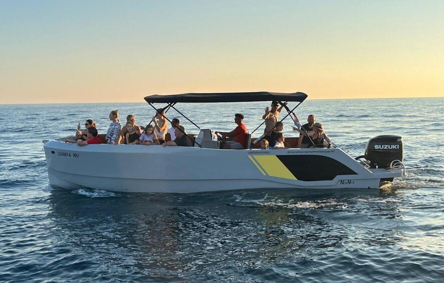 A white motorboat with a Suzuki engine on the water. 2