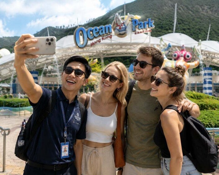 A group of people taking a selfie in front of Ocean Park Hong Kong. 3