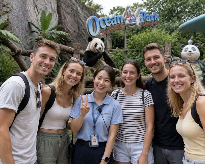 A group of people at Ocean Park Hong Kong with panda statues in the background. 1