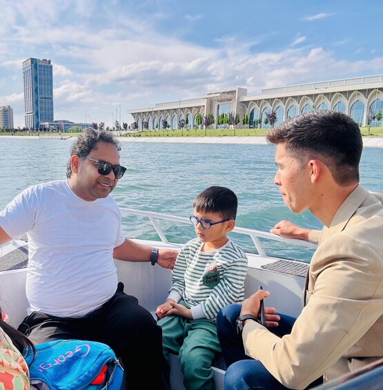 Three people on a boat with a cityscape and a building labeled 'Glengarry Center' in the background. 2