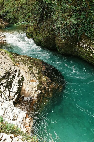 A river flowing through a rocky gorge with lush greenery. 3