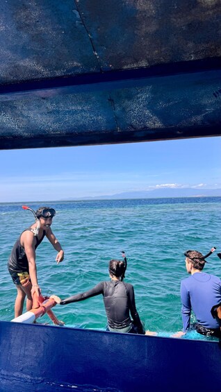 A group of people snorkeling in the ocean. 5