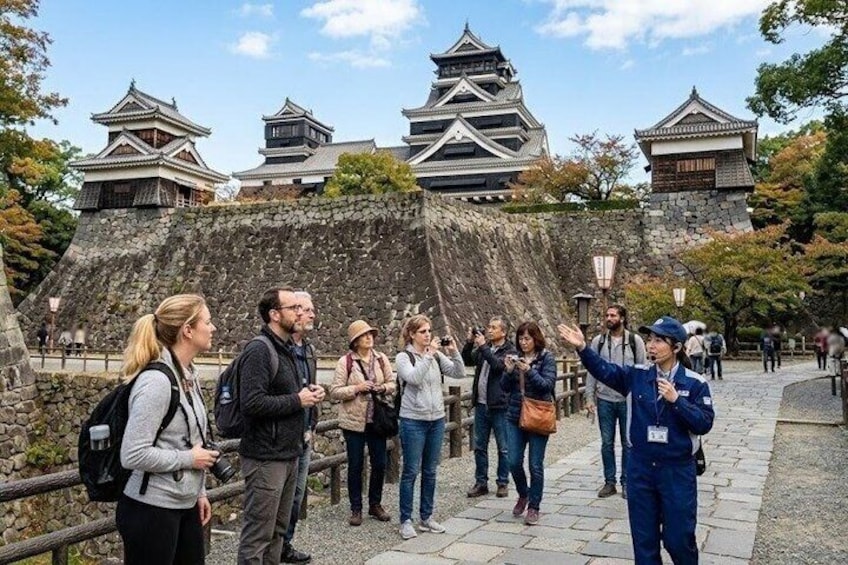 Tourists at a historical site with traditional architecture. 1