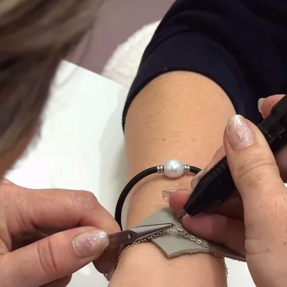 A person getting a tattoo on their forearm. 2