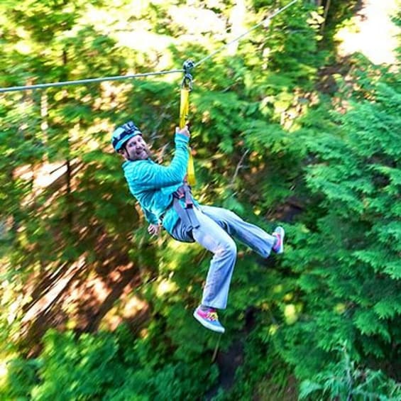 A person zip-lining through a forest. 5