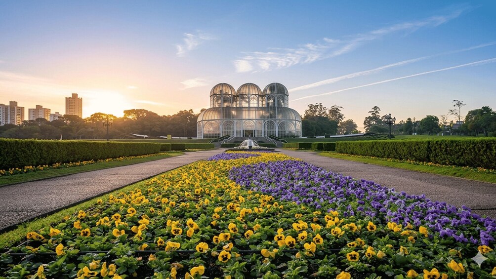 A garden with a glasshouse, flower beds, and a fountain. 1