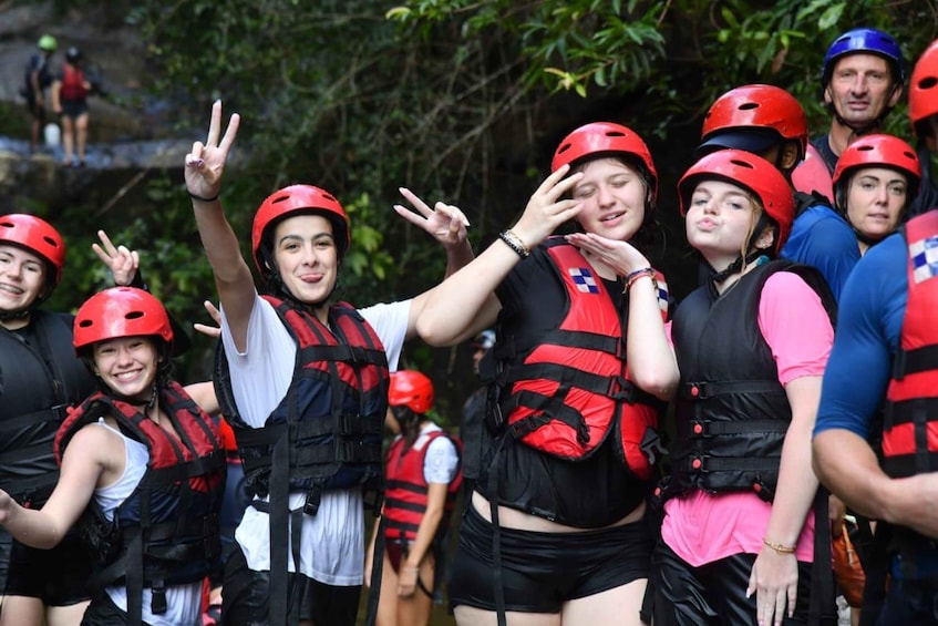 A group of people wearing helmets and life vests, likely participating in an outdoor activity. 5
