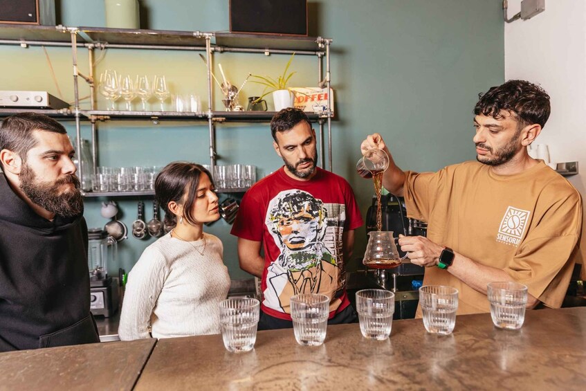 A bar setting with a bartender pouring drinks into glasses. 3