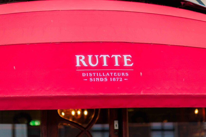 A red awning with the text 'RUTTE DISTILLATEURS SINDS 1872' on it. 4