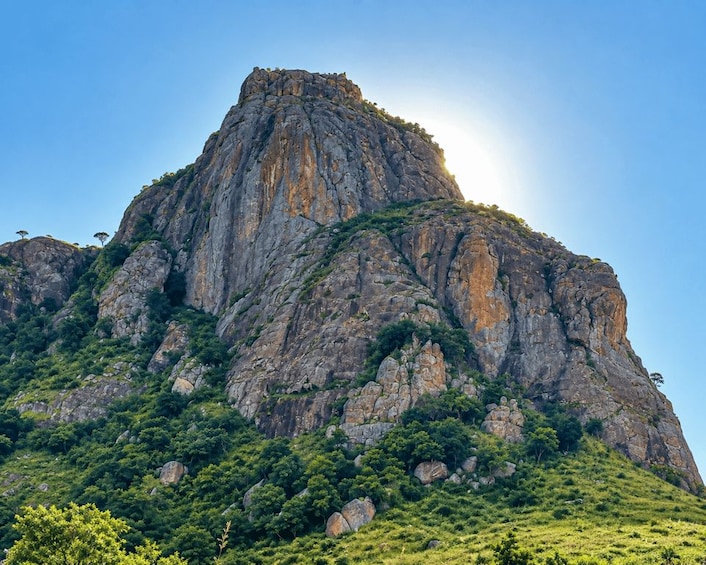 A rugged mountain peak with a clear sky. 2