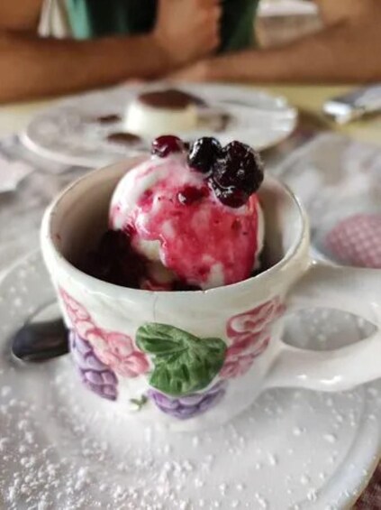 A cup of ice cream with a cherry on top. 4