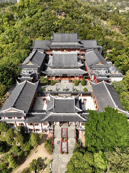 A traditional multi-tiered pagoda surrounded by lush greenery. 5
