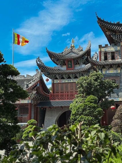 A traditional Chinese building with ornate architecture and a flag. 2