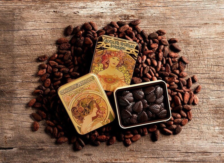 A tin of chocolate, a tin of cocoa beans, and a chocolate bar on a wooden surface. 5