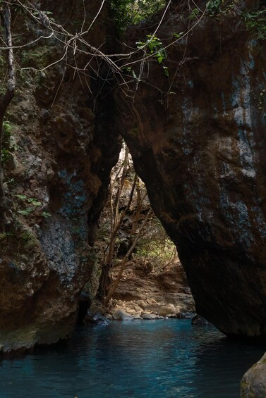 A natural rock formation with a water stream flowing through a narrow passage. 2