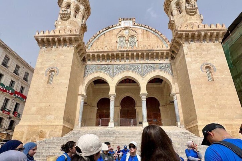 A historic building with arches and a tower. 4