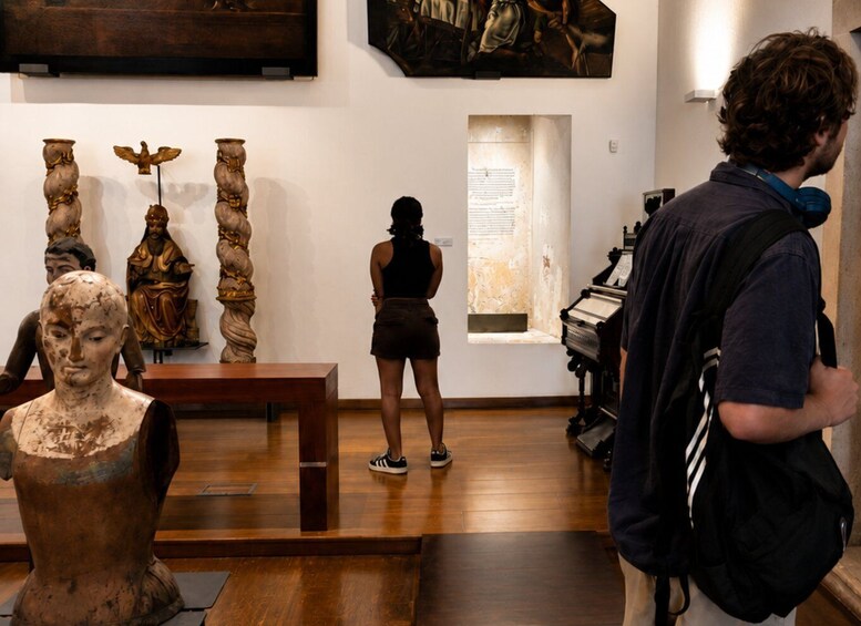 A museum interior with sculptures and paintings on display. 5