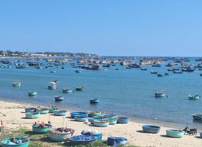 A coastal scene with numerous boats docked along the shore and scattered across the water. 1