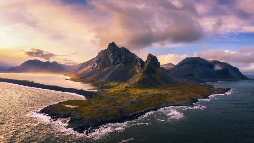 A rugged coastline with prominent mountains and a calm sea. 3