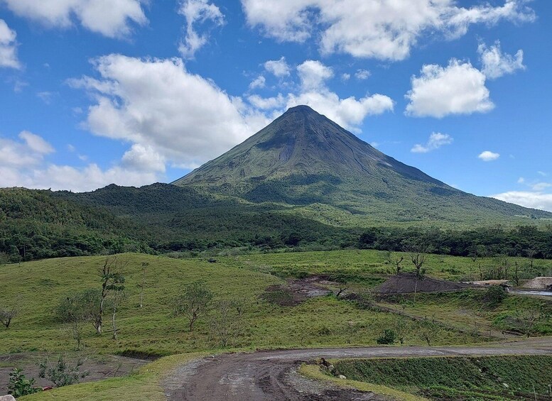 A mountain with a clear sky and scattered clouds. 2
