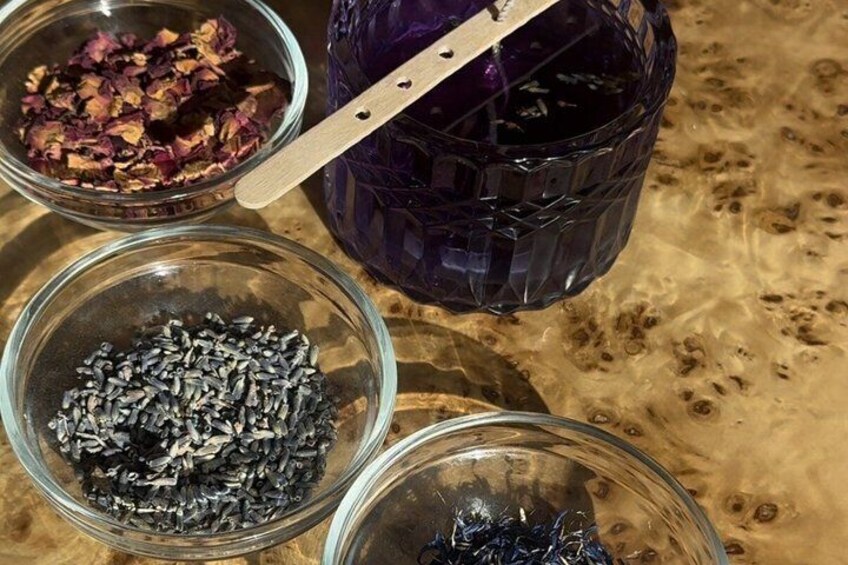 Three glass bowls with dried flowers and seeds, and a purple glass container with a wooden handle. 3