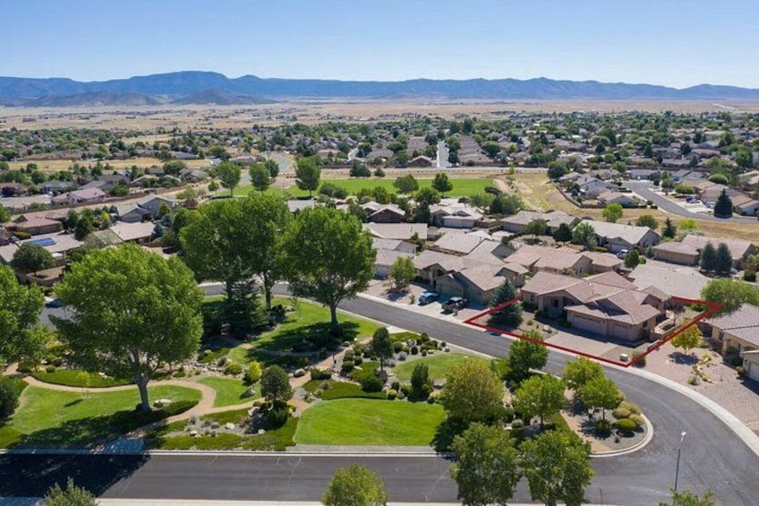 A suburban neighborhood with houses, trees, and a curved road. 2