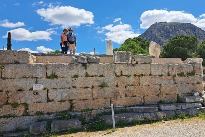 A stone wall with ruins and a mountain in the background. 5