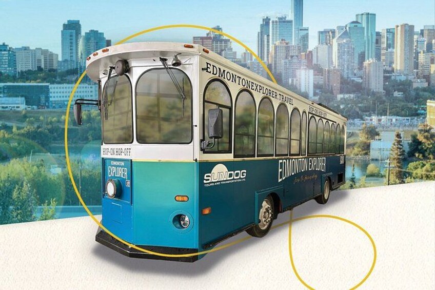 A bus with 'EDMONTON EXPLORER' and 'SLAM' branding, parked on a road with a cityscape and greenery in the background. 2
