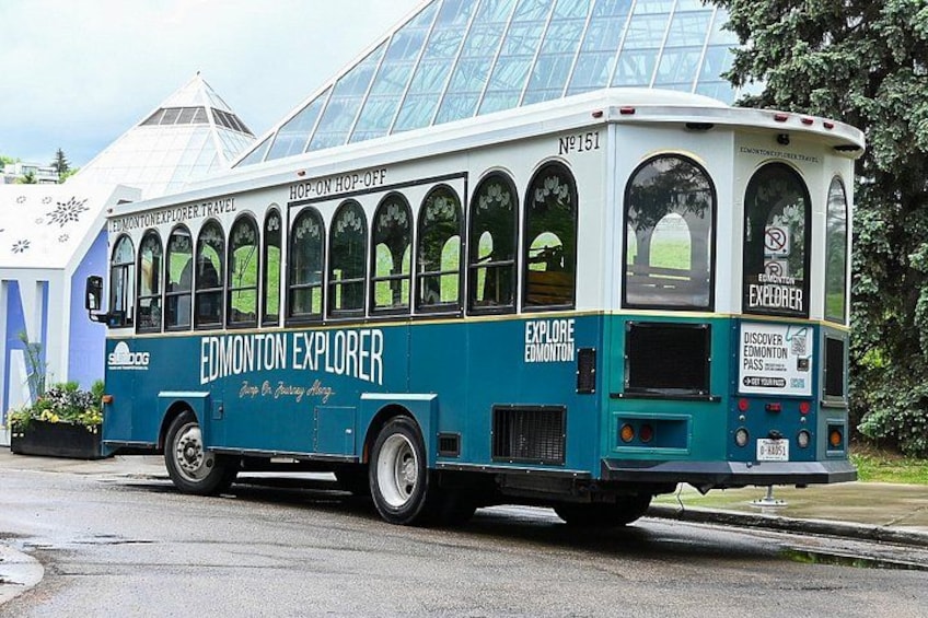 A blue and white bus with 'Edmonton Explorer' written on the side, parked on a street. 5