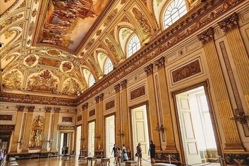 An ornate interior with high ceilings, large windows, and classical architecture. 1