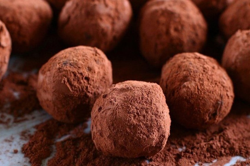 Round chocolate truffles covered in cocoa powder. 4