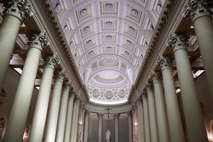 A grand hall with ornate columns and a detailed ceiling. 3