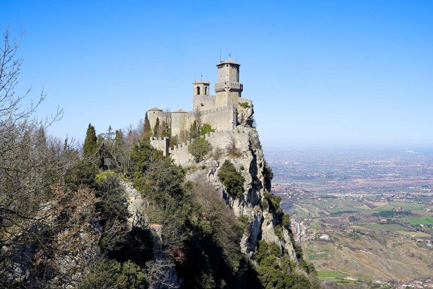 A historic castle perched atop a cliff, overlooking a valley. 4