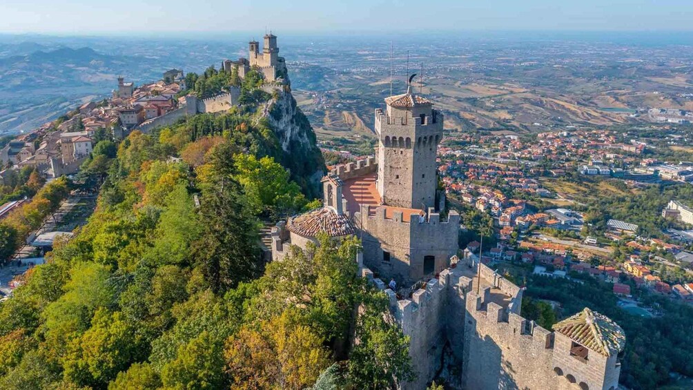 A historic castle perched on a hill overlooking a town. 1