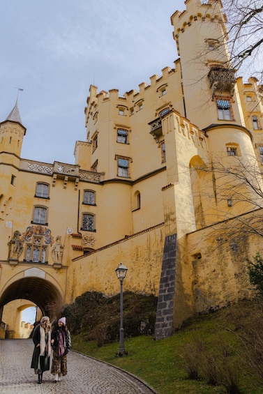 A castle with a tower, a bridge, and a cobblestone path. 4