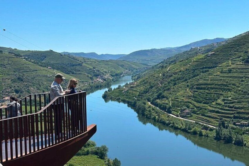 A river winding through terraced vineyards under a clear sky. 1
