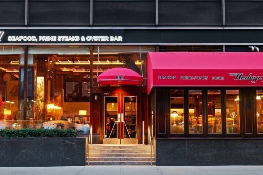 A seafood restaurant with a red awning and a glass entrance. 1