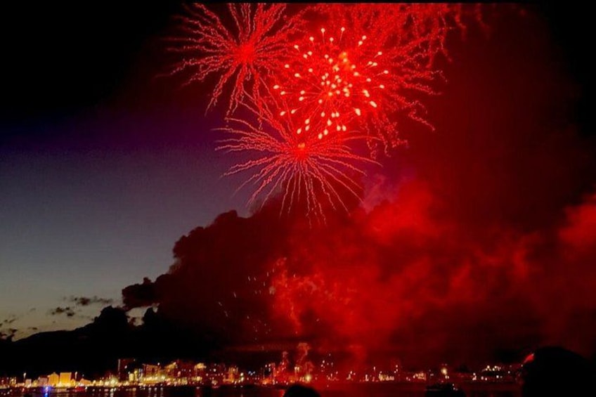 Fireworks illuminating the night sky over a cityscape. 1