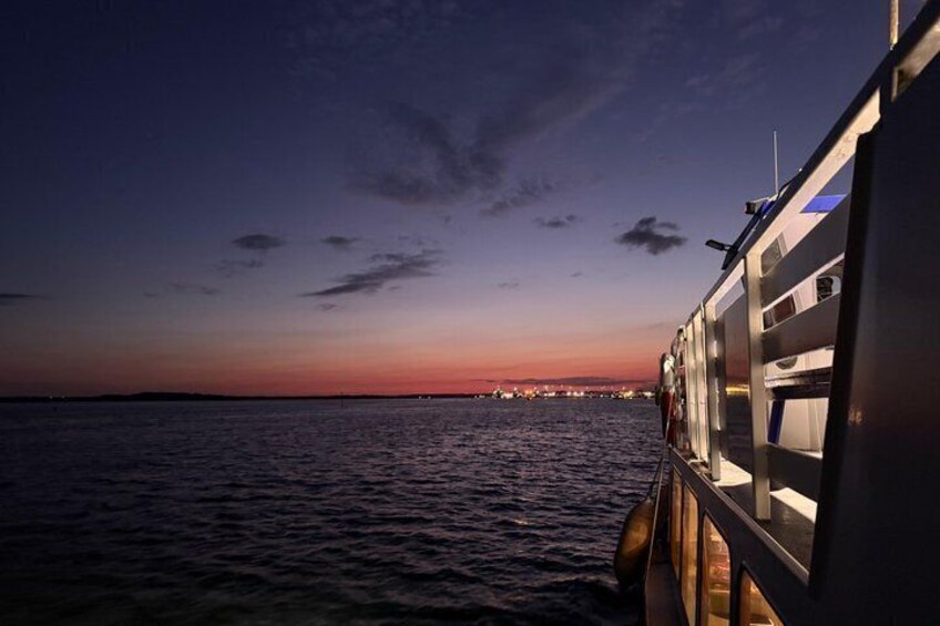 A sunset over water with a boat on the right. 3