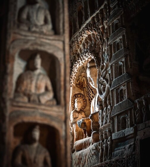 Intricate stone carvings of seated figures and architectural details. 4