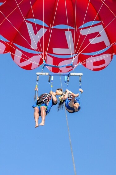 Two people bungee jumping from a bridge. 5