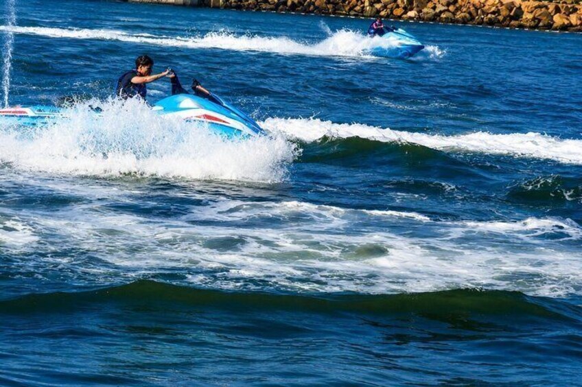 A person jet-skiing on a body of water with waves. 3