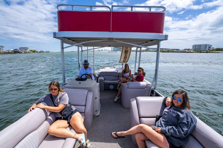 A boat with a covered seating area and passengers. 5